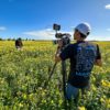 A MoMac videographer filming a company in a flower field in Christchurch